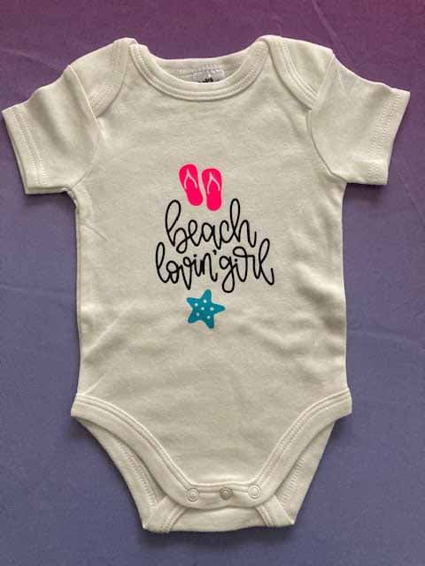 Cream cotton baby bodysuit with 'beach lovin girl' custom print design featuring pink flip flops and blue starfish, short-sleeve summer-themed infant onesie for baby girls by AJ's Infinity Design